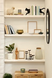 Many shelves with different decor in room. Interior design