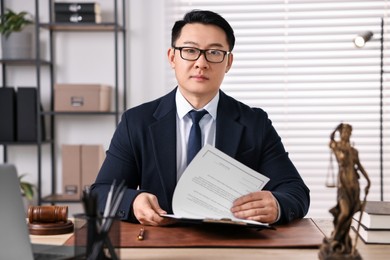 Photo of Notary working at wooden table in office