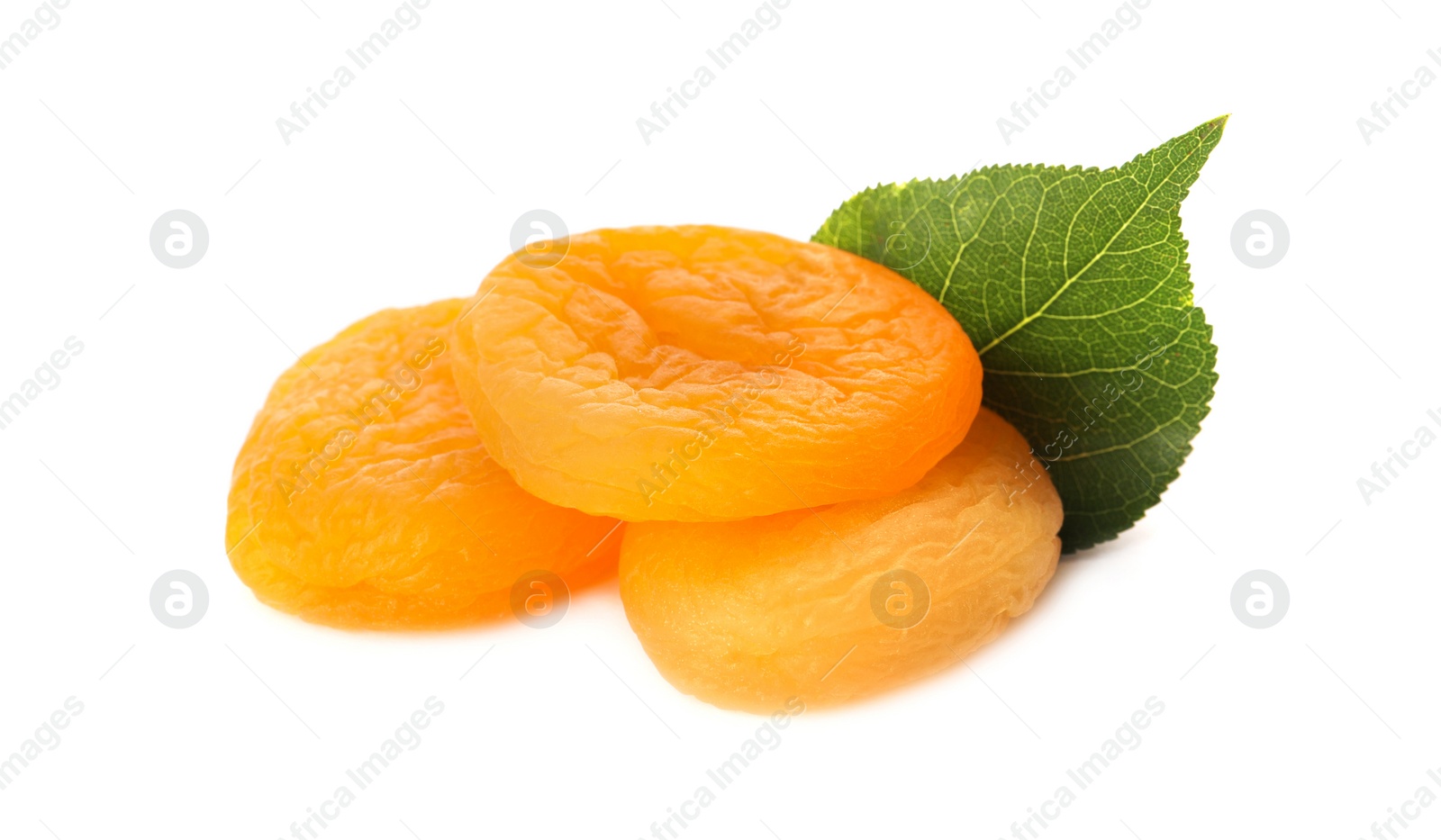 Photo of Tasty apricots and green leaf on white background. Dried fruits