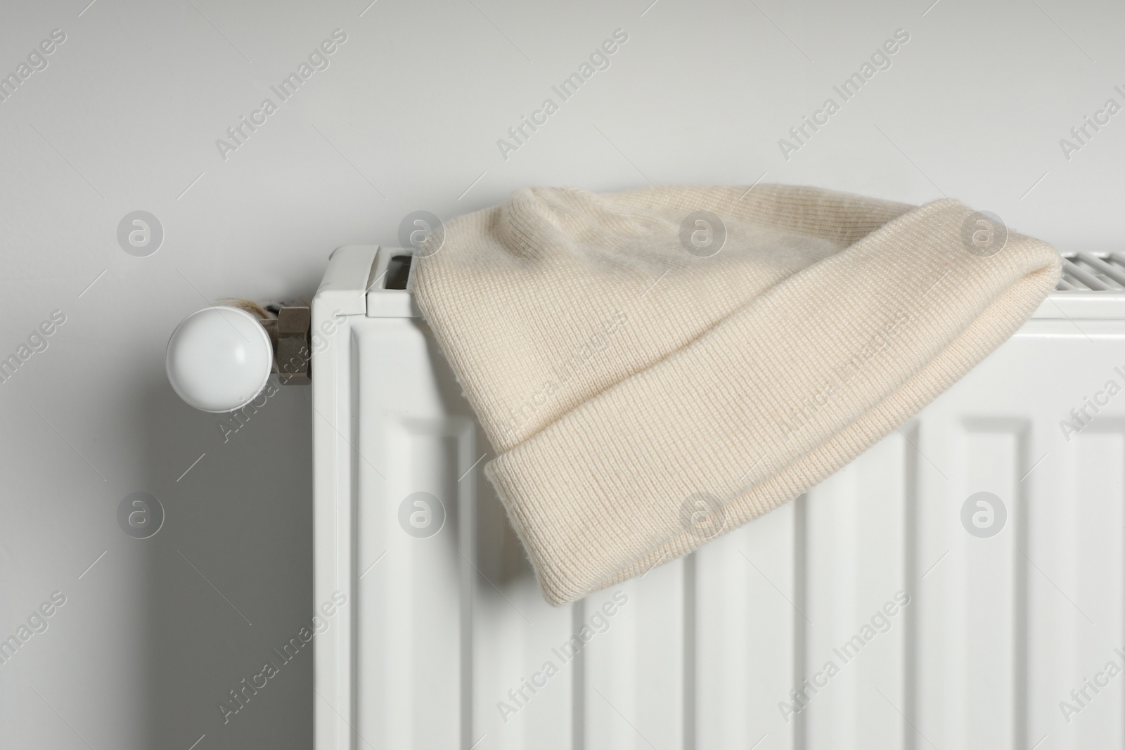 Photo of Beige hat on white radiator in room