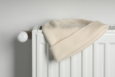 Photo of Beige hat on white radiator in room