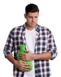 Man using hot water bottle to relieve abdominal pain on white background