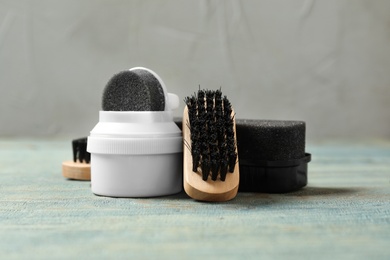 Photo of Composition with shoe care accessories on wooden table, closeup