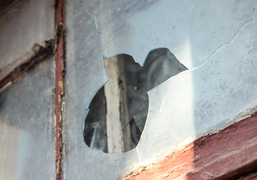 Photo of Broken window of abandoned house outdoors. Requiring repair