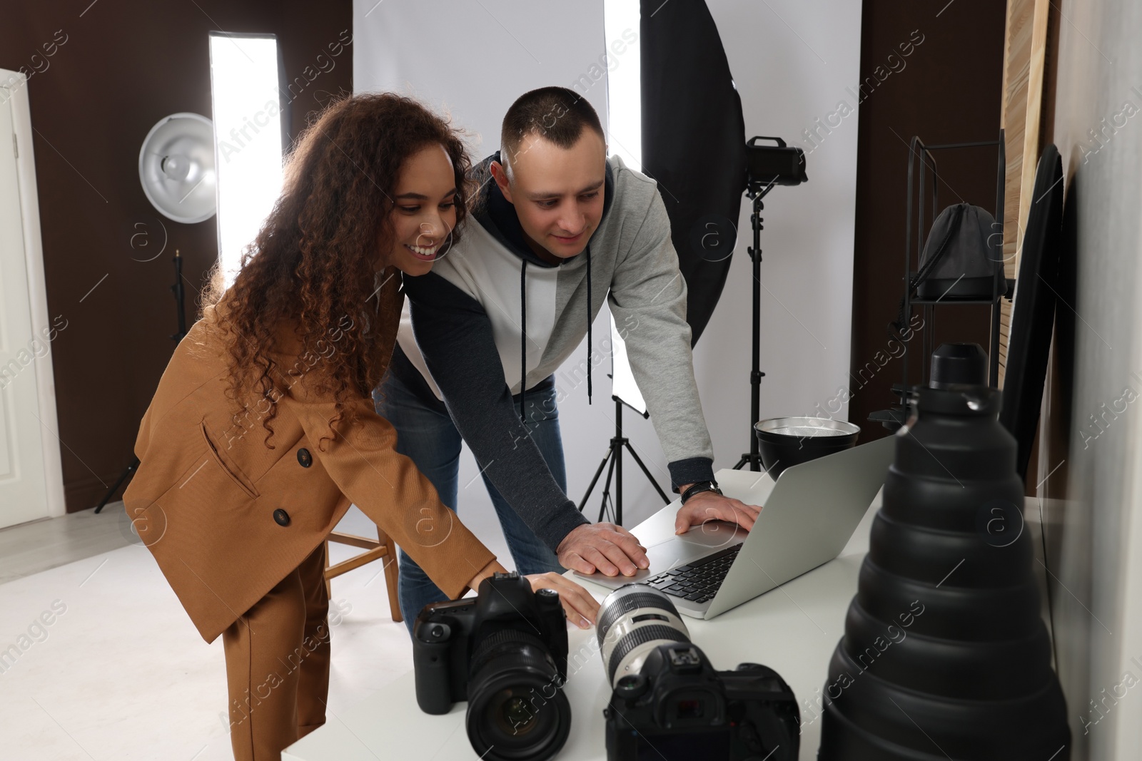 Photo of Beautiful African American model with professional photographer in studio