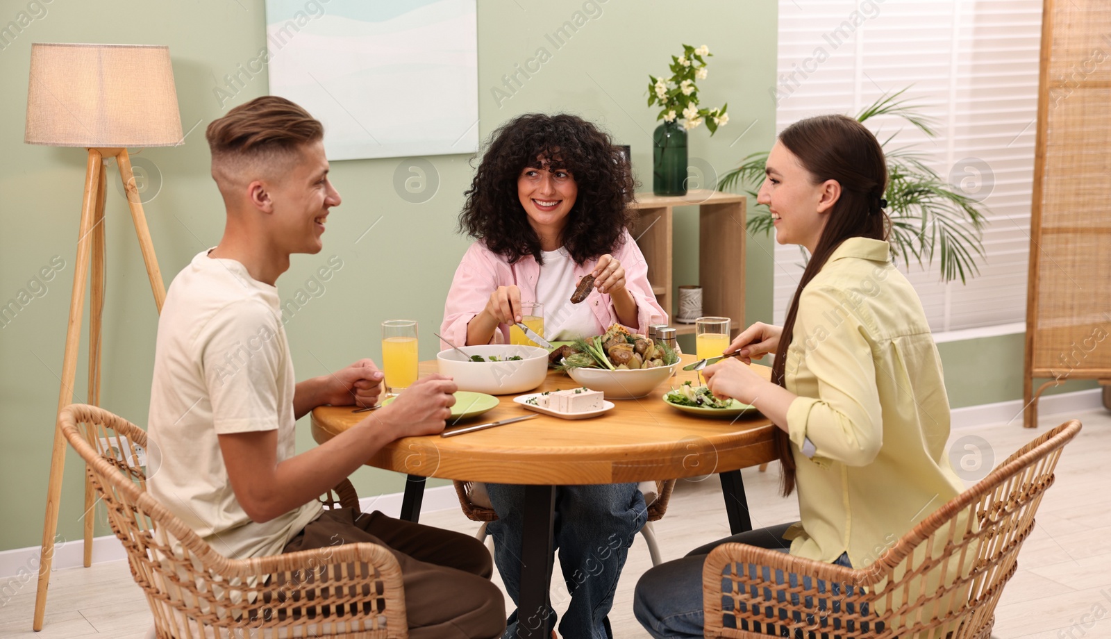 Photo of Friends having vegetarian meal at table in cafe