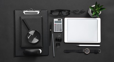 Photo of Flat lay composition with modern tablet on black background. Space for text