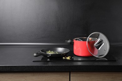 Dirty pot and frying pan on cooktop in kitchen, space for text
