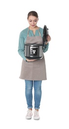 Full length portrait of young woman with modern multi cooker on white background