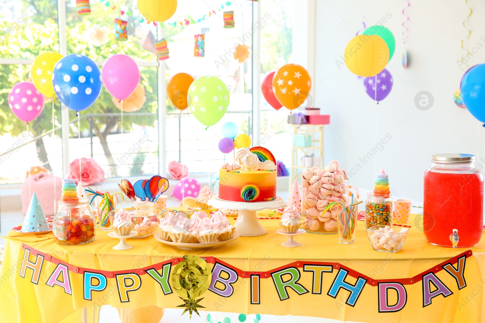 Photo of Table with birthday cake and delicious treats indoors