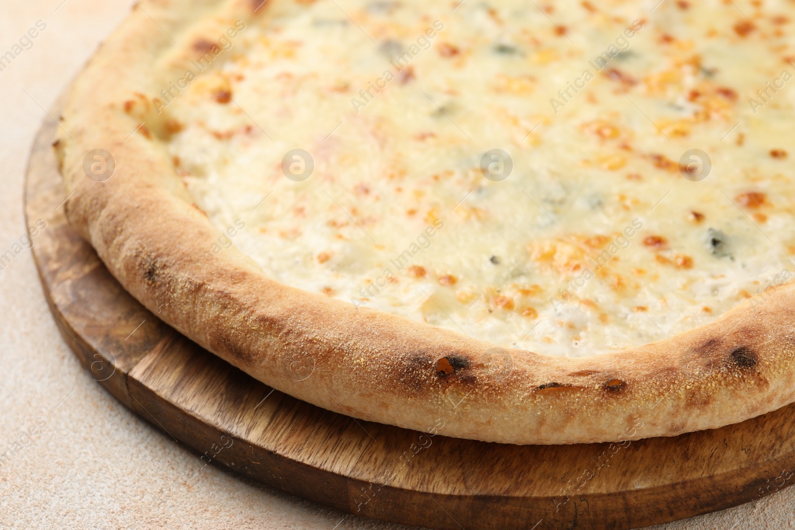 Photo of Delicious cheese pizza on beige textured table, closeup