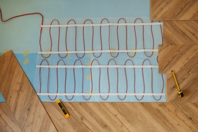 Photo of Installation of electric underfloor heating system indoors, top view