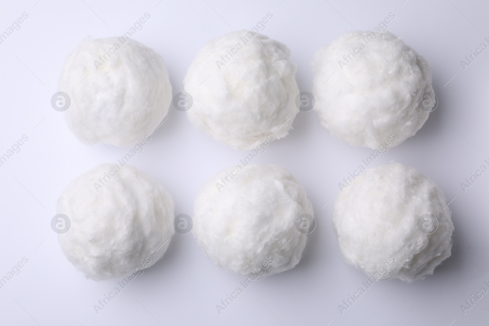 Photo of Balls of clean cotton wool on white background, top view