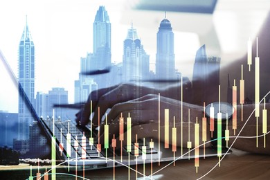 Image of Innovation concept. Multiple exposure of man working on laptop, cityscape and charts