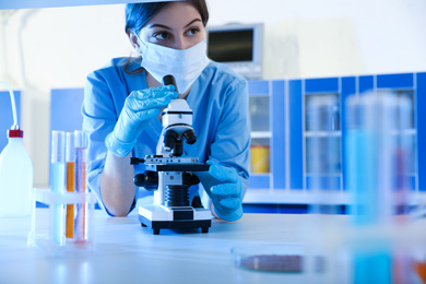 Scientist working with microscope indoors. Laboratory analysis