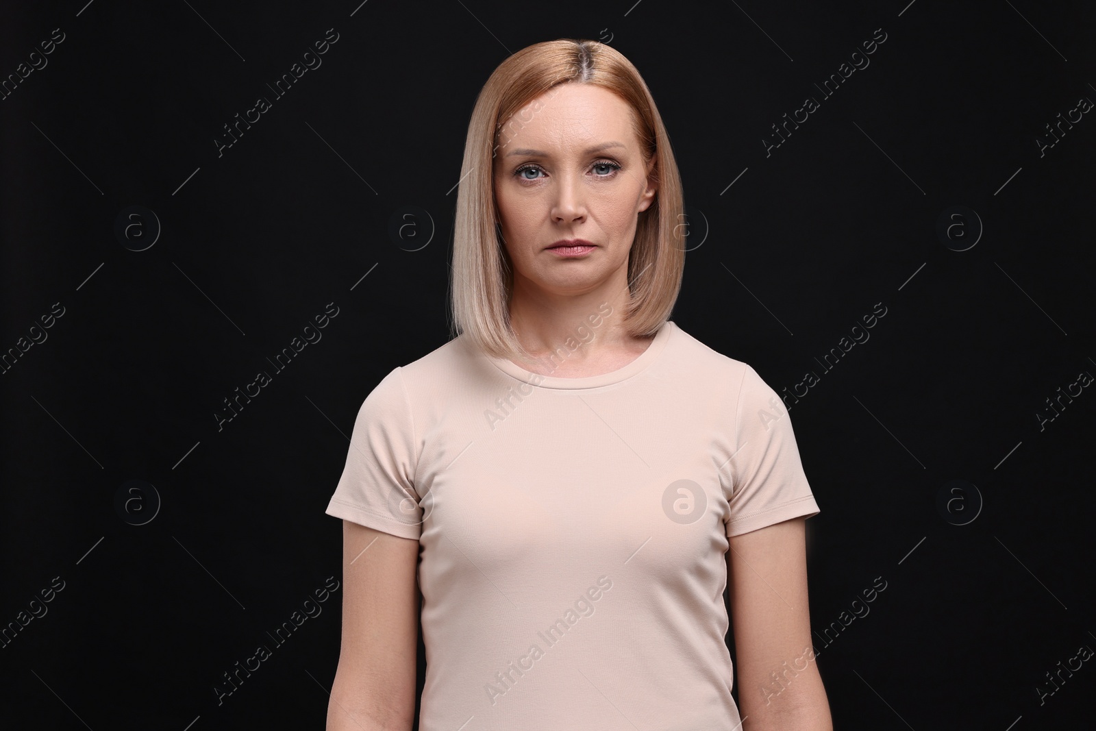 Photo of Portrait of sad woman on black background