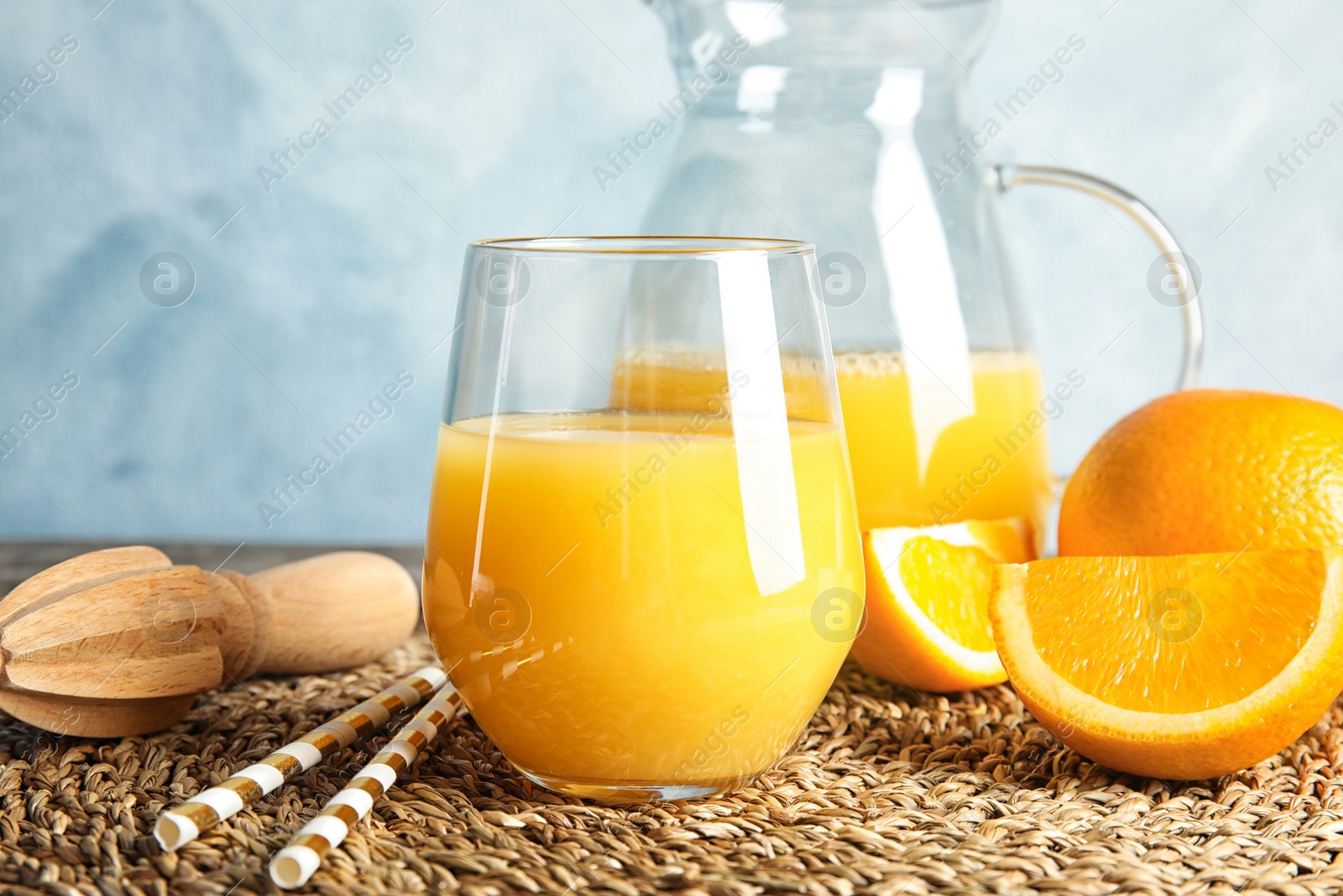 Photo of Composition with orange juice and fresh fruit on table