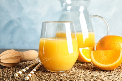 Composition with orange juice and fresh fruit on table