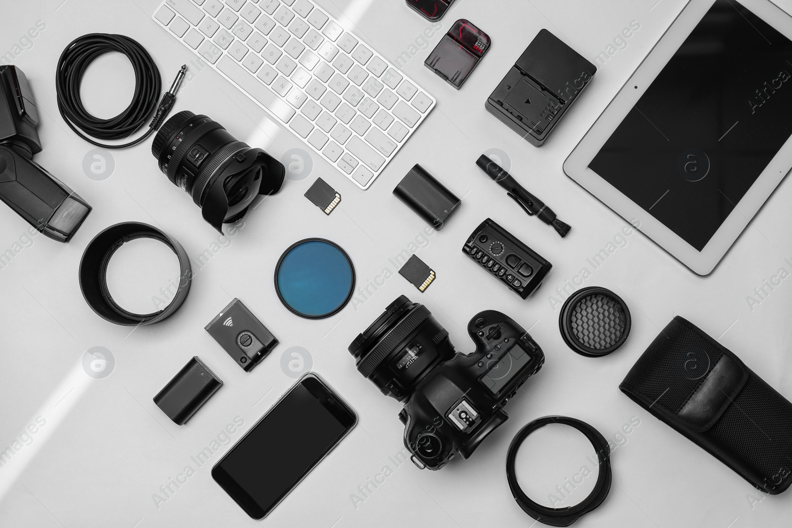 Photo of Flat lay composition with equipment for professional photographer on white background