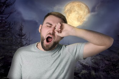 Sleepy young man and beautiful view of full moon in night sky