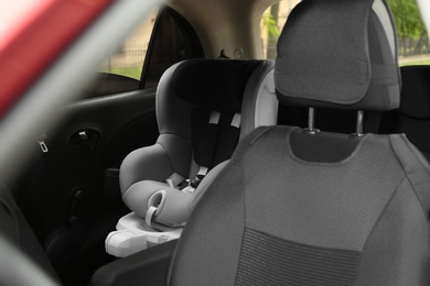 Photo of Child safety seat on backseat in car. Danger prevention