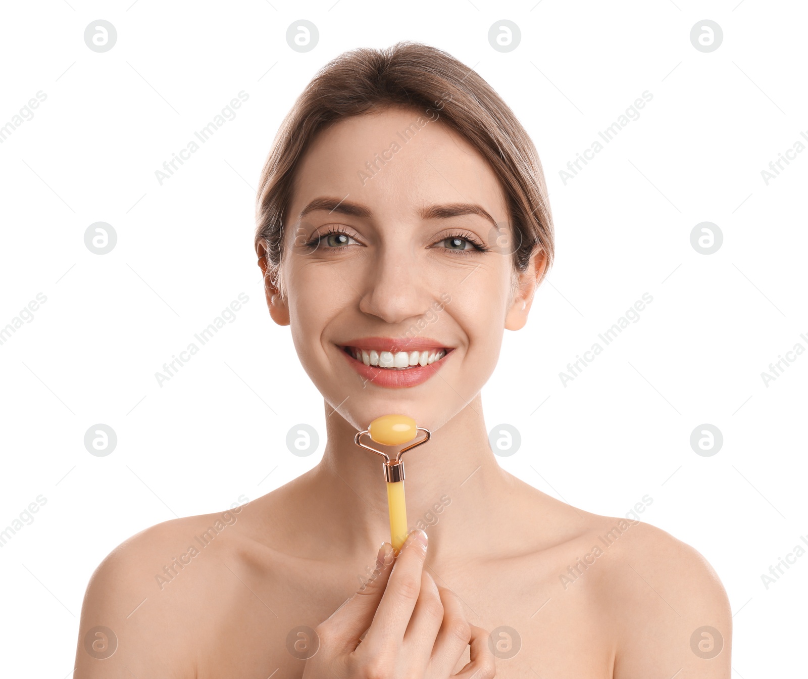 Photo of Young woman using natural jade face roller on white background