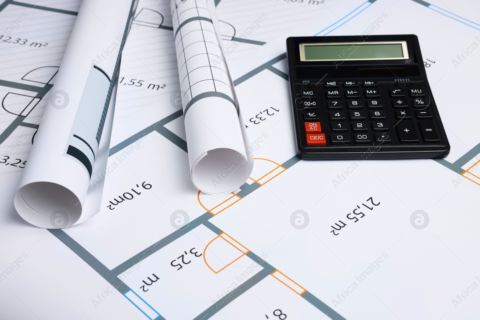 Photo of Construction drawings and calculator on house plan. Architect workspace