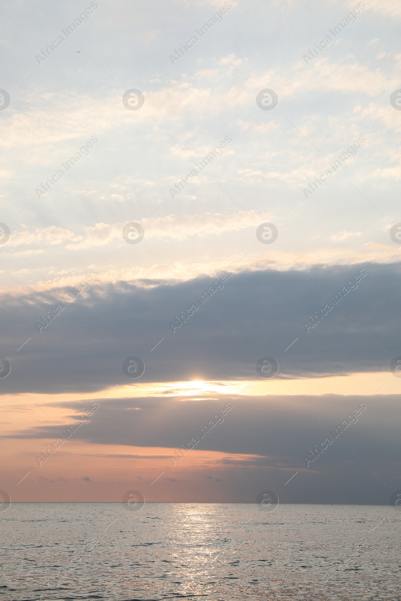 Photo of Picturesque view of sunset with beautiful clouds over sea