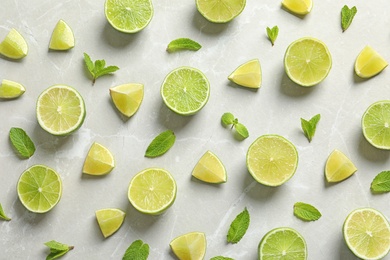 Photo of Composition with fresh ripe limes on light background, top view