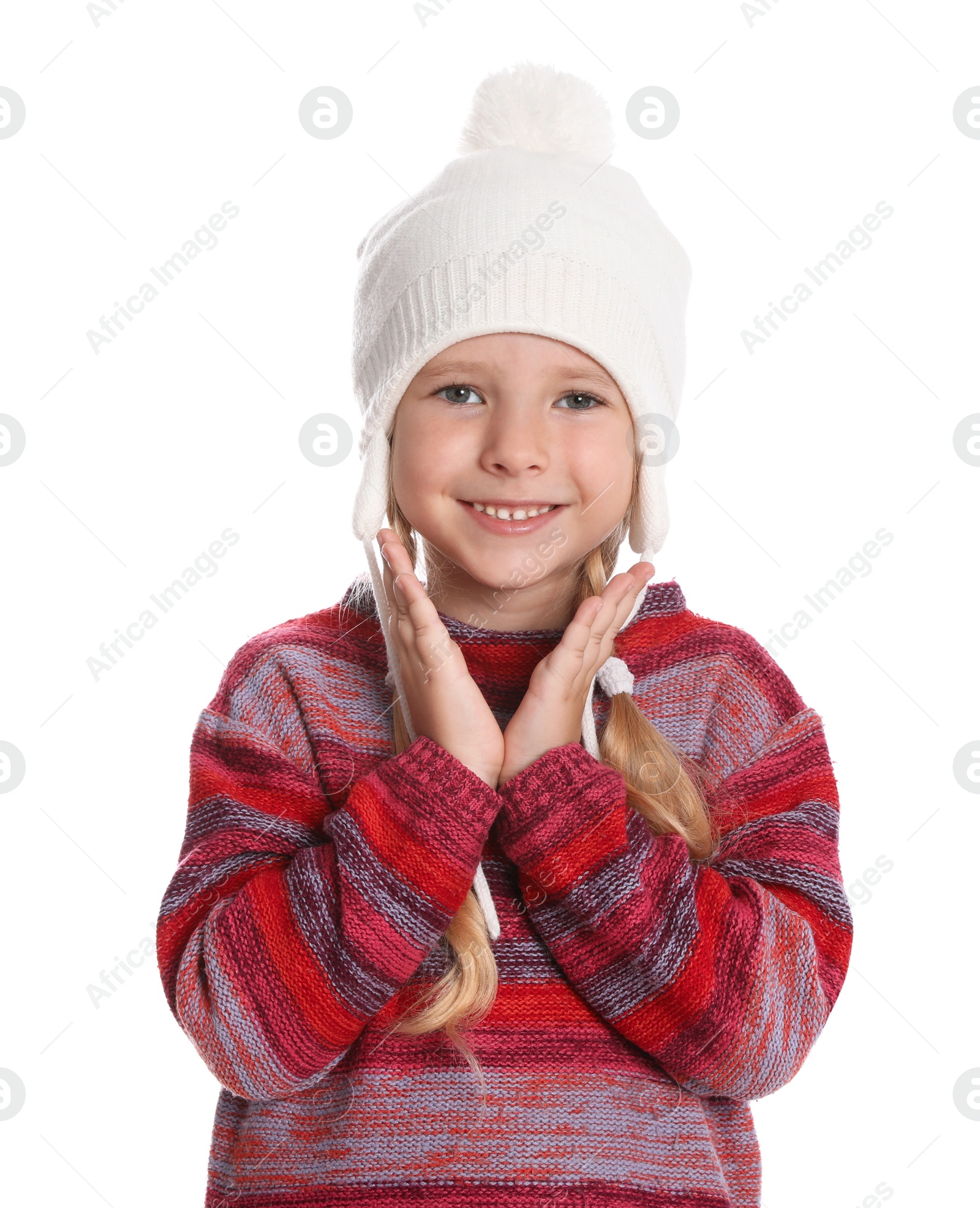 Photo of Cute little girl in warm sweater and hat on white background. Winter season