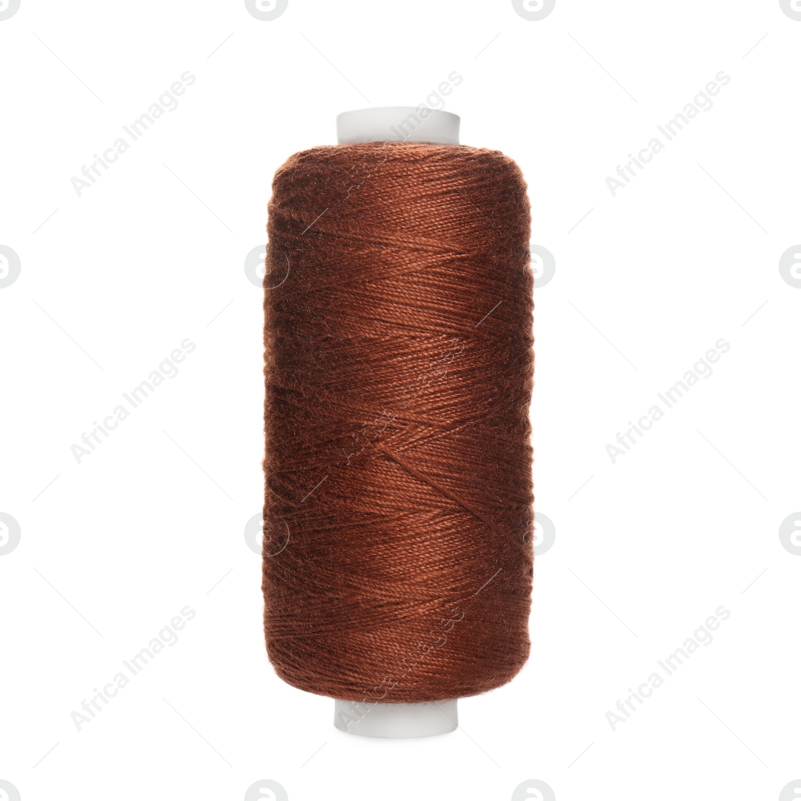 Photo of Spool of brown sewing thread isolated on white