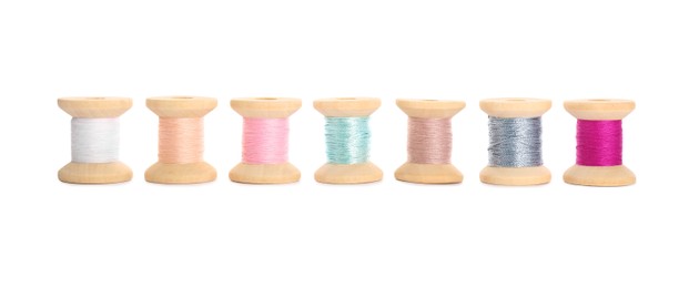 Photo of Set of colorful sewing threads on white background