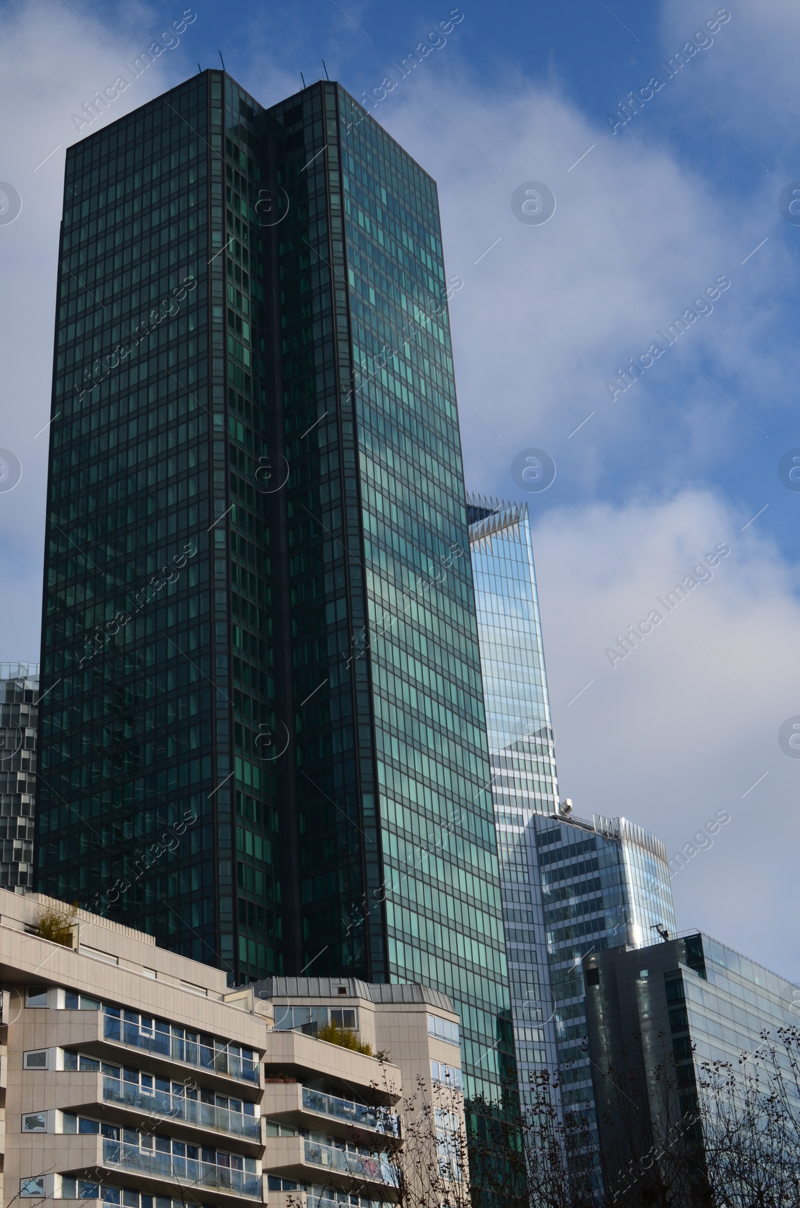 Photo of Exterior of different modern skyscrapers against blue sky