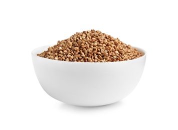 Bowl with uncooked buckwheat on white background