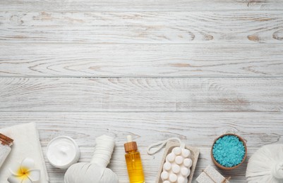 Flat lay composition of herbal bags and spa products on white wooden table, space for text