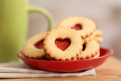 Photo of Traditional Christmas Linzer cookies with sweet jam on table