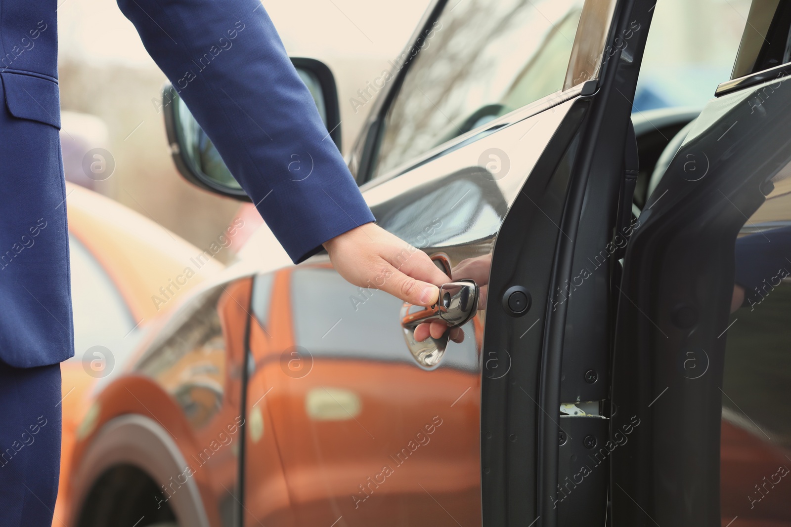 Photo of Closeup view of man opening car door