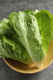 Photo of Fresh green romaine lettuces on light grey table, above view