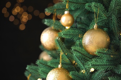 Photo of Beautiful Christmas tree with festive decor against blurred lights on background