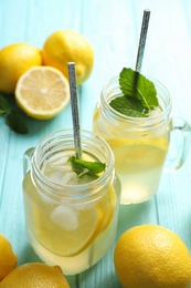 Natural lemonade with mint on light blue wooden table. Summer refreshing drink