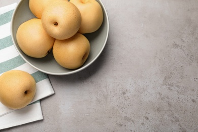 Photo of Fresh apple pears on grey table, flat lay. Space for text