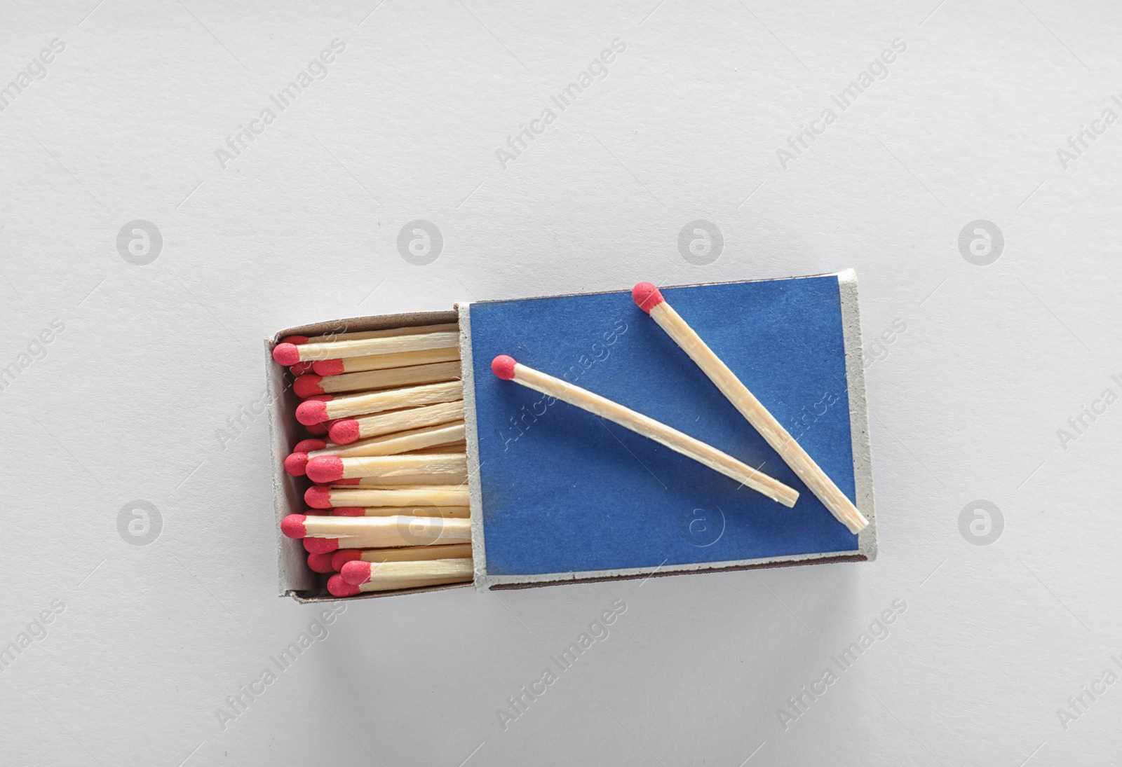 Photo of Cardboard box with matches on white background, top view