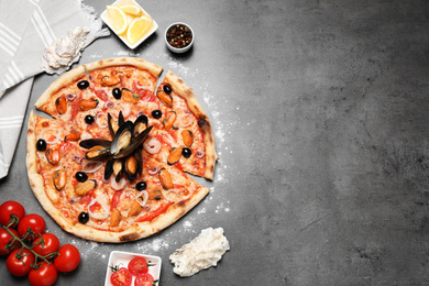 Tasty pizza with seafood and ingredients on grey table, flat lay. Space for text