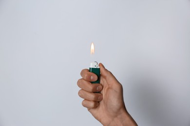 Photo of Woman holding lighter on white background, closeup