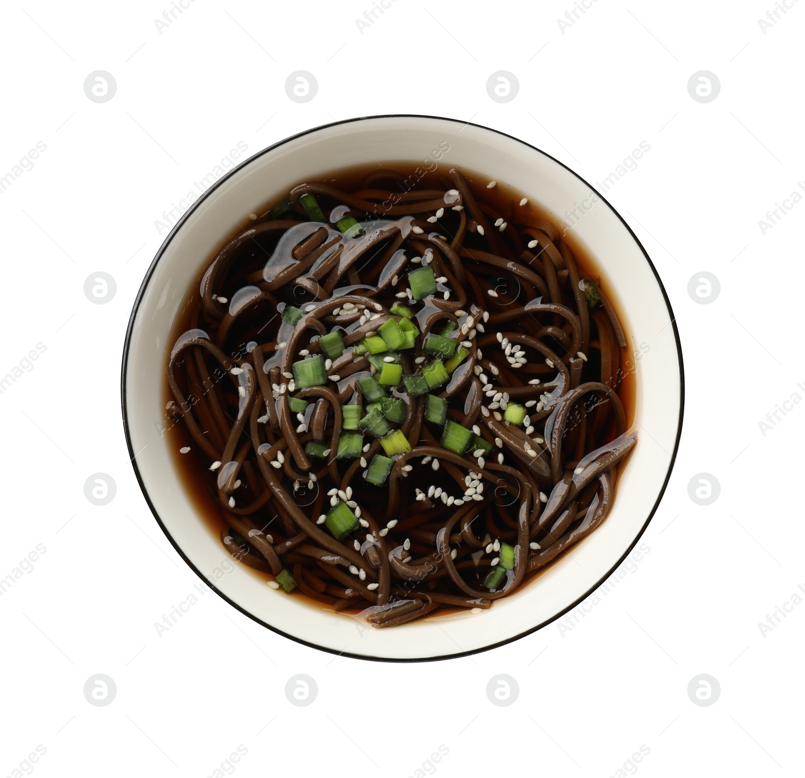 Photo of Tasty soup with buckwheat noodles (soba), onion and sesame in bowl isolated on white, top view