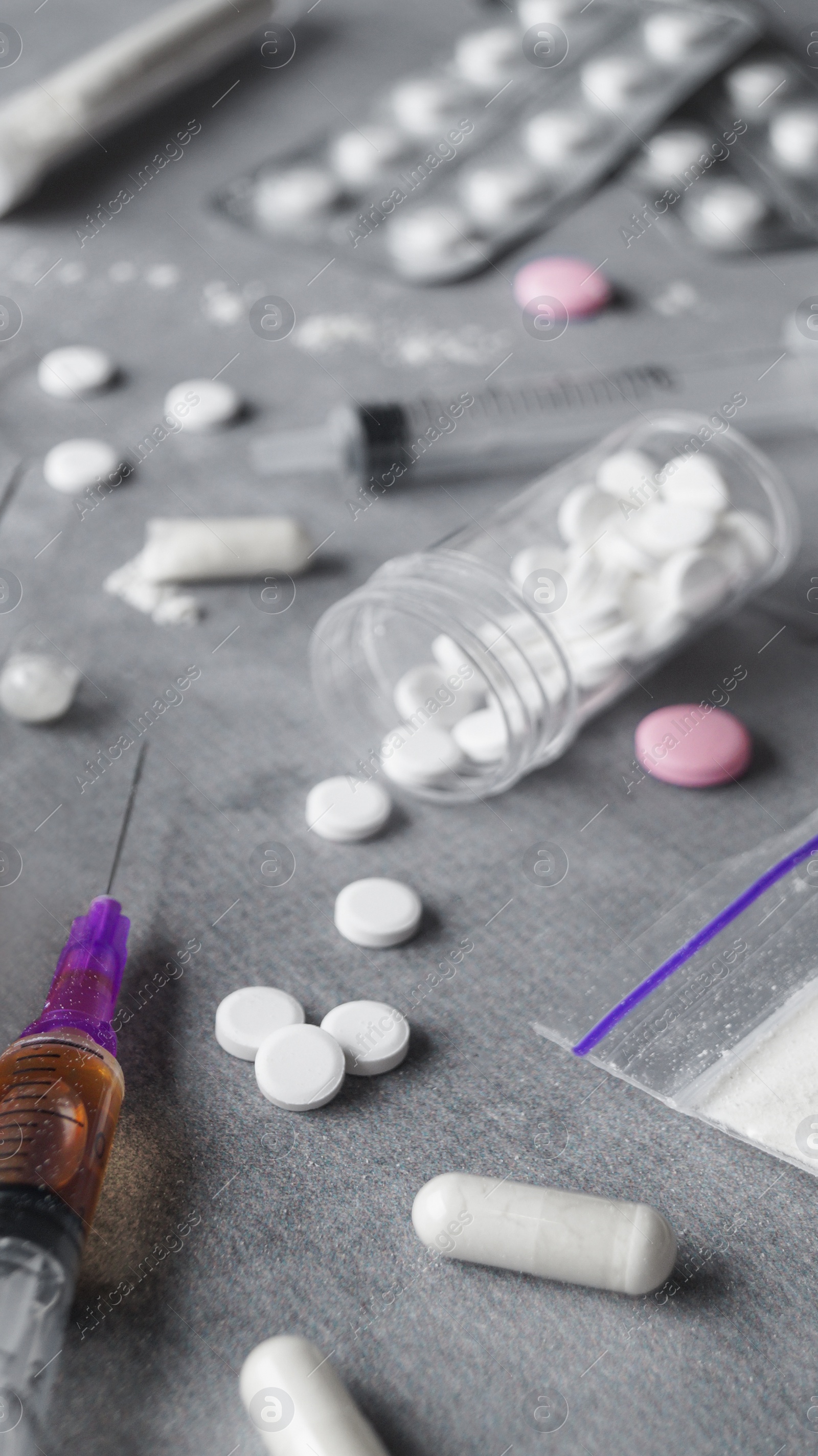 Photo of Different hard drugs on grey table, closeup