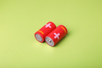 Photo of New C size batteries on light green background