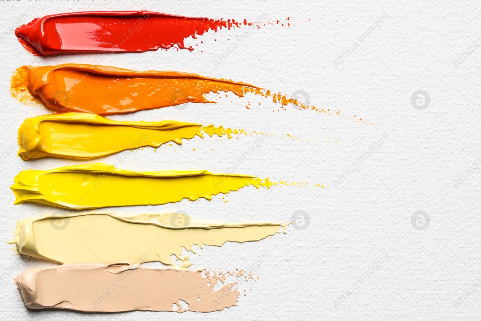 Photo of Beautiful strokes of colorful oil paints on white canvas, closeup. Space for text