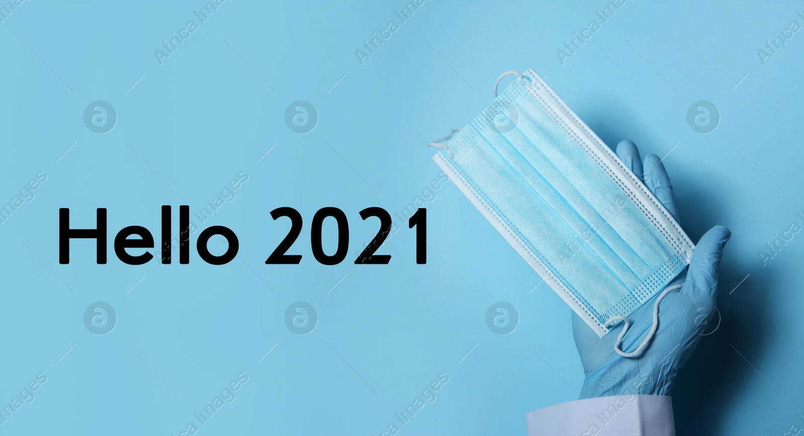 Image of Hello 2021. Doctor in gloves holding disposable face mask on light blue background, closeup