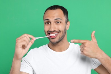 Portrait of happy man with bubble gum on green background